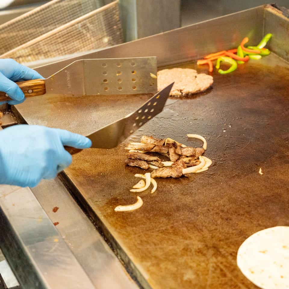 Cooking meat and vegetables on the griddle